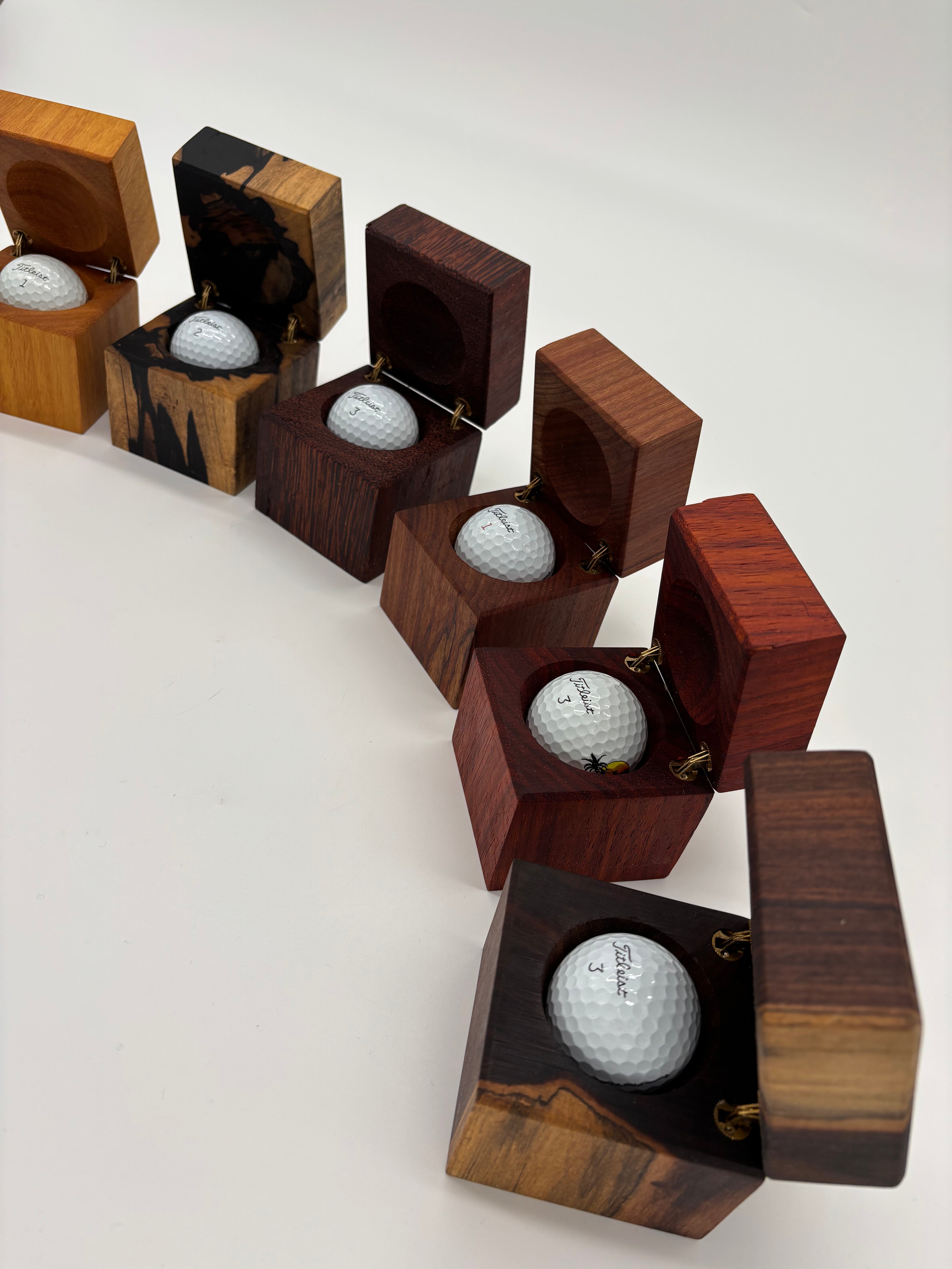 Multiple wood species of Condor Hole-In-One Boxes.